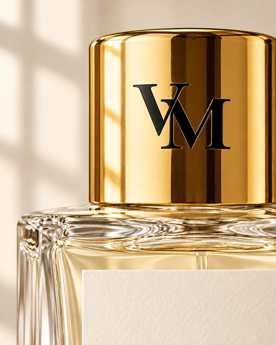 Detail of the gold VM cap and clear glass bottle shoulder