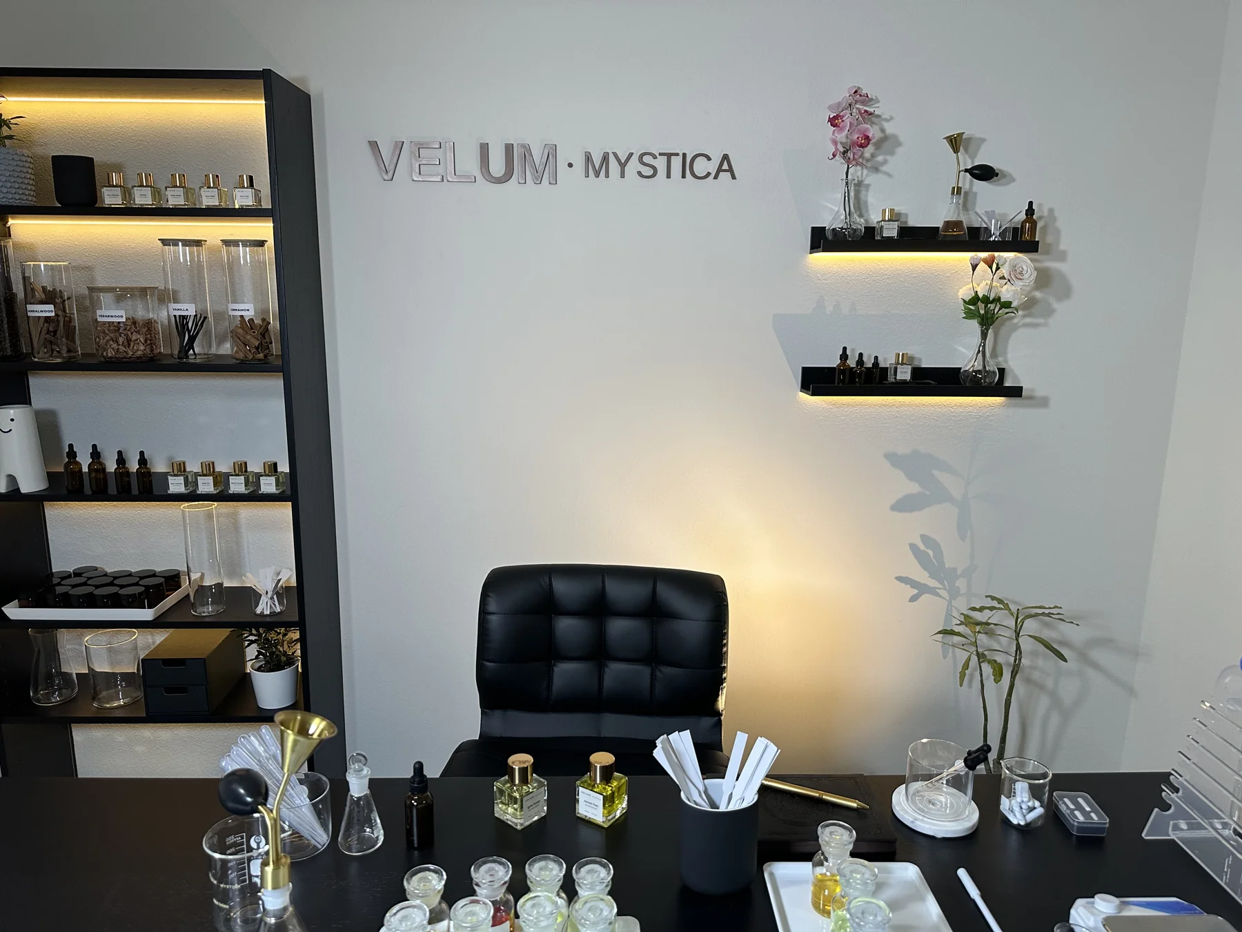 The Velum Mystica perfume studio, with fragrance materials, bottles, and blending tools on the workbench